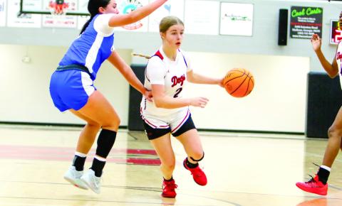 Morgan County sophomore guard Madison Holcomb (2) dribbles down the lane as she tries to make a basket against an Oconee County defender. LANCE McCURLEY/Staff