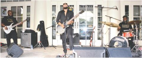 At least one happy couple outwaited the wet stuff to share a dance to the sounds of Cash’s Juke Joint, playing Saturday afternoon on the steps of The Plaza Arts Center in Eatonton.
