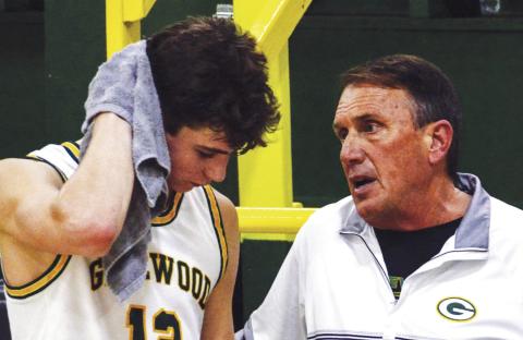 Gatewood head coach Don Keiser talks with leading scorer Matt Allen during a break last Friday night during a game against Mount de Sales Academy out of Macon. IAN TOCHER/Staff
