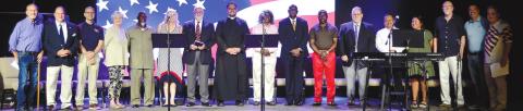 Prayer participants include, from left, Rob Reiner, Mark Jones III, Tim Oliver, Rosa Sides, AJ Bryant, Meg Jackson Clark, Ford G’Senger, Father Michael Silloway, Avis Williams, Herman Laguins, Mayor Corey Williams, Dennis Mitchell, Havier Ortiz, Edith Ortiz, Lee Smith, Jonathon Dawson and Fran D’Antonio. CONTRIBUTED