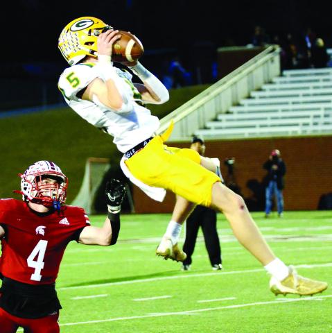 Blake Callaway leaps high in the air to complete just one of at least three outstanding catches he made on the night in the state title game at Mercer. IAN TOCHER/Staff