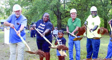 Helping to toss the ceremonial first shovelfuls of dirt alongside Standish Avenue was Putnam County Commission Chairman Bill Sharp (left), beside soon-to-be homeowner Tawana Ellison and her four-year-old daughter Gracelyn. (IAN TOCHER/Staff)