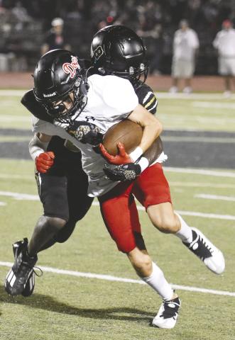Greene County’s Chris Lowe brings down Morgan County’s Drew Cole as he fights for a first-down. LANCE McCURLEY/Staff