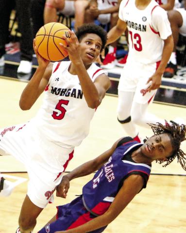 Morgan County’s Kobi Jefferies (5) tries to go over a Putnam County defender as he tries to make a contested basket. LANCE McCURLEY/Staff