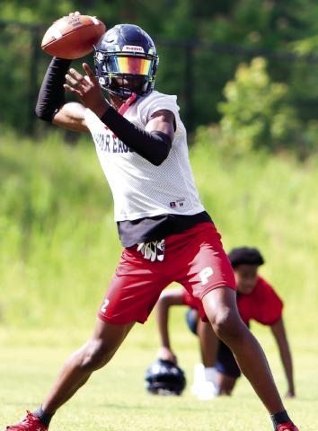 Putnam County quarterback Jamarion Robertson drops back to pass during a practice in June. (LANCE MCCURLEY/Staff)