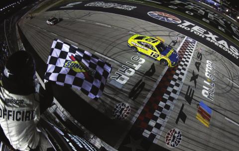 Ryan Blaney, driver of the #12 Menards/Wrangler Ford, takes the checkered flag to win the Cup Series All-Star Race at Texas Motor Speedway Sunday. (Sean Gardner/Getty Images)