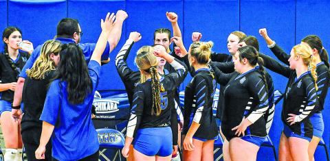 The Lady Titans circle up before one of their home matches late in the season. CHARLES JORDAN/Staff