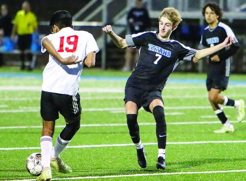 Lake Oconee Academy senior Palmer Larkin (7) tries to prevent GMC Prep senior Adi Patel (19) from advancing the ball downfield. LANCE McCURLEY/Staff