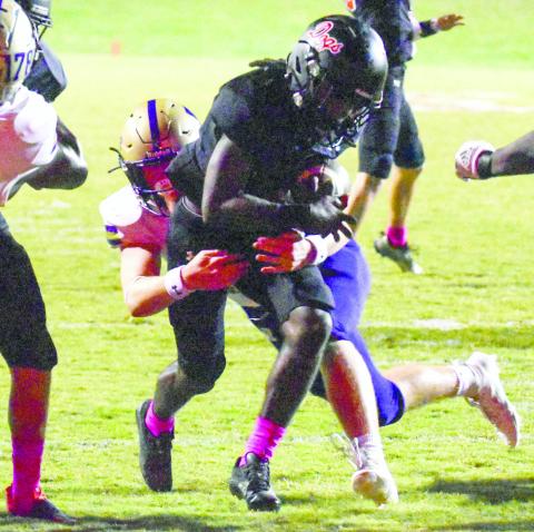 Bulldog running back Jaydon Dorsey drags a Musketeer defender down the field in last week's contest against ARC. LANCE MCCURLEY/Staff