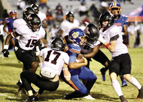 A trio of Morgan County defenders brings down Cedar Shoals freshman quarterback Keelin McLendon (15). JIM TURNER/Contributed