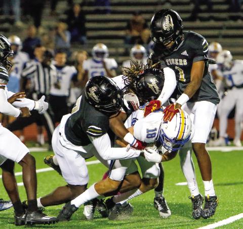 A trio of Greene County defenders bring Lake Oconee Academy wide receiver Cason Bennett (18) to the ground. LANCE McCURLEY/Staff