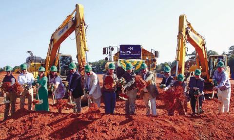 Representatives of Gatewood Schools, including Headmaster Jeff Decker, Assistant Headmaster Josh Ringer and Director of Development Marie Rainey, among others, joined several local officials in tossing a ceremonial shovelful of dirt for the official groundbreaking of Gatewood’s new high school. IAN TOCHER/Staff