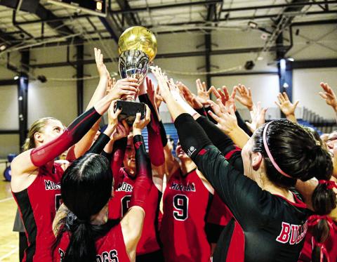 The Spike Dogs hoist up the Class 2A state championship trophy after defeating the Savannah Arts Academy in straight sets on Saturday, Nov. 2, at the LakePoint Sports complex in Emerson. CHARLES JORDAN/Staff