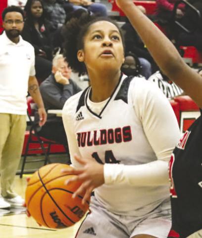 Jaden Young (14) drives the lane against a Lady Rebels’ defender in Friday night’s 62-43 win. LANCE McCURLEY/Staff