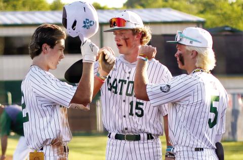 Gatewood’s Ben Brannen (2), Lawson Wooten (15), and Caleb Riser (5) celebrate after winning game one last Friday against the Warriors. TREY NORRIS/Staff