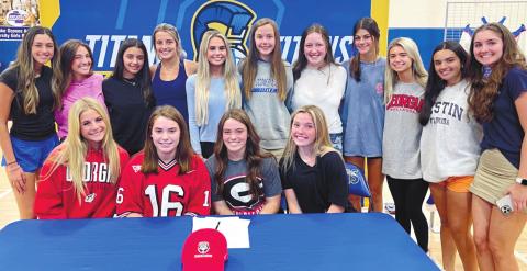 Ally Blythe (center) poses for a picture with her teammates and friends at her signing ceremony last Wednesday. CONTRIBUTED