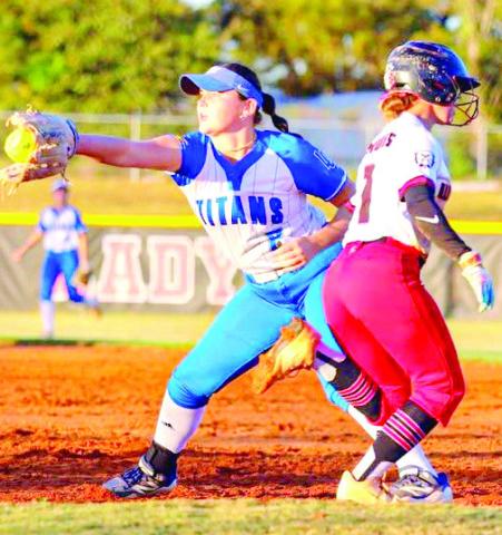 LOA’s Elizabeth Moore (2) tries to make a play at first base as a Wheeler County baserunner tries to beat the throw to the bag. CONTRIBUTED
