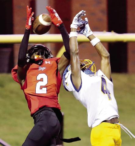 Morgan County wide receiver Jaylen Elder (2) hauls in a pass over a Warren County defender in a game earlier this season. Elder had a career game this past Friday against Jackson. JIM TURNER/File photo