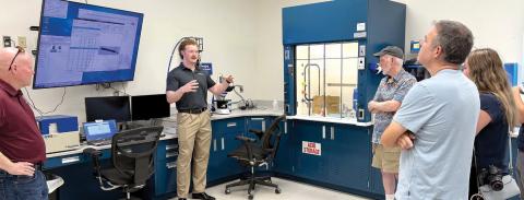 Piedmont Water lab supervisor Kyle Craig (second from left) speaks to visitors about his work in the site’s microbiology lab. CONTRIBUTED