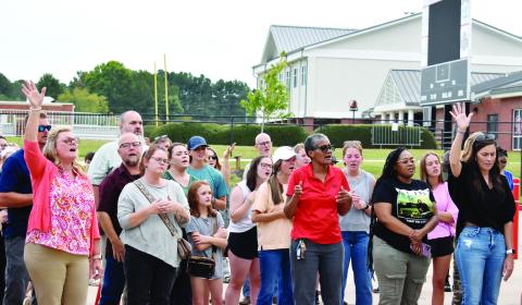 Attendees join in song during a prayer vigil held at Morgan County High School Sept. 10. (HANNAH BARRON/Staff)