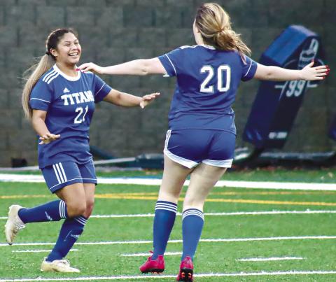 A pair of Lake Oconee Academy players celebrate after a goal last season against Greene County. LANCE McCURLEY/Staff