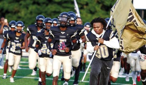 The Tigers take the field before their scrimmage against Northeast of Macon on Aug. 8, 2025. LANCE McCURLEY/Staff