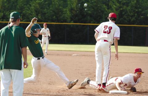 Morgan County first baseman Drew Ainslie (7) makes a dive to tag first and get the runner out in last Monday’s game against Savannah Country Day. BRENDAN KOERNER/Staff