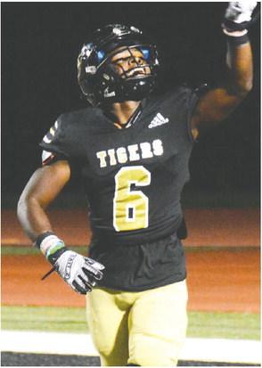 Javaris Harris (6) smiles as he pitches the ball to the referee after scoring his second touchdown of the evening against Warren County a few weeks ago. BRENDAN KOERNER/Staff