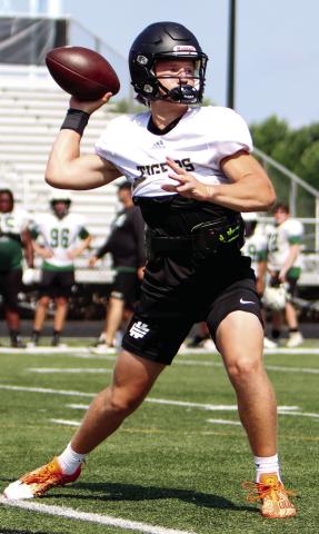 Greene County quarterback Landon Garretson, a transfer this season from Kell High School, drops back to pass during a camp at Social Circle in June. LANCE McCURLEY/Staff