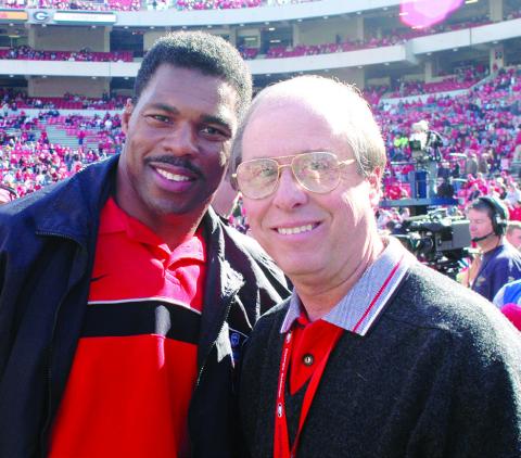 Two of the best-ever at their chosen crafts: Bulldogs’ football legend and 1982 Heisman Trophy winner Herschel Walker (left) with UGA’s legendary Sports Information and Communications Director Claude Felton on Dooley Field at Sanford Stadium in Athens. COURTESY OF UGA ATHLETICS