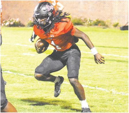 Bulldogs’ senior running back Jaydon Dorsey (1) runs behind his blockers in a win over Monroe Area on Sept. 15. LANCE McCURLEY/Staff