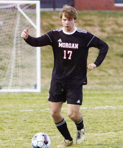 Mogan County senior Carson Keener dribbles the ball up the field during a match against Jackson on March 18. LANCE MCCURLEY/Staff