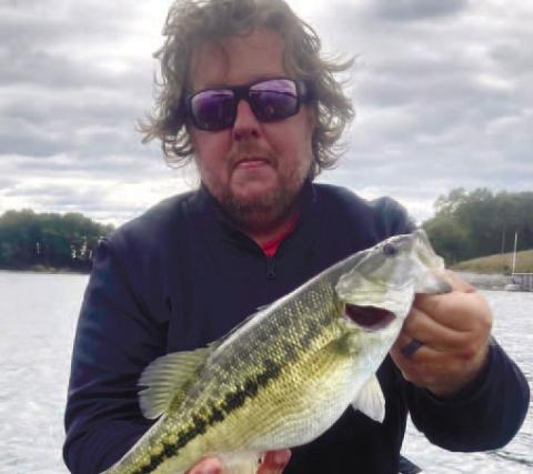 Pressley with a spotted bass on Lake Lanier.