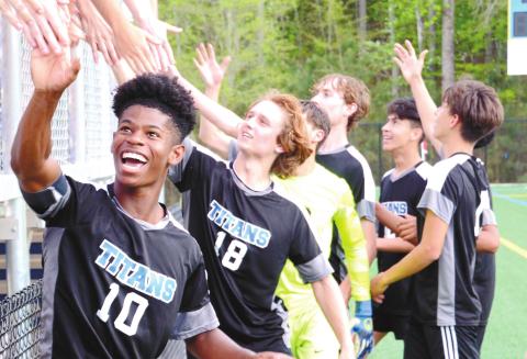 Kyle Beasley (10) and the rest of the Lake Oconee Academy soccer team celebrates with their supporters after their 1-0 win against Armuchee High School in the first round of the state playoffs. BRENDAN KOERNER/Staff