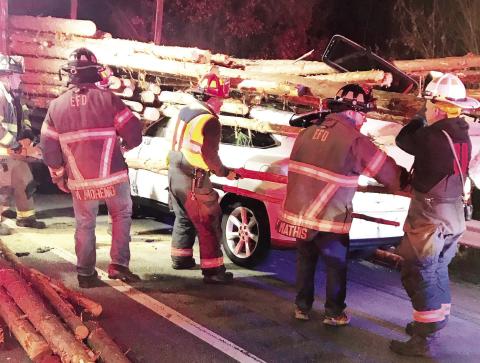 Eatonton Fire Department first responders work to rescue a driver trapped in an SUV after crashing into a log truck Monday. (Contributed by EPD)