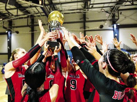The Spike Dogs hoist up the Class 2A state championship trophy after defeating the Savannah Arts Academy in straight sets on Saturday, Nov. 2, 2024, at the LakePoint Sports complex in Emerson. CHARLES JORDAN/Staff