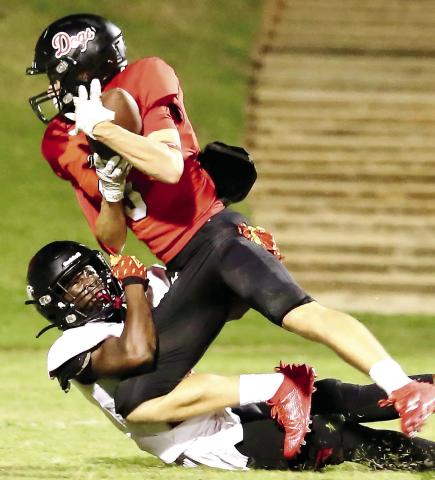 Former Morgan County wide receiver Dallas Dickerson tries to secure a catch as a defender brings him down to the ground during a game in 2023. JIM TURNER/Contributed