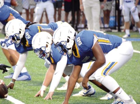 The Titans’ defensive front lines up during a home game against George Walton Academy earlier this season. BRENDAN KOERNER/Staff