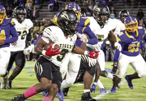 Greene County running back Amari Durham (9) rushes past Washington-Wilkes defenders in Friday night’s region matchup. COURTESY OF MOMMA D’S PIX