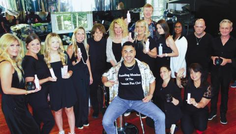 Sporting a custom-made t-shirt in honor of Zapien’s Salon founder Norman Zapien (5th from left), Carlos Rojas is surrounded by Zapien’s colorists and stylists after giving a personal demonstration June 23, of Schwarzkopf Professional’s hair coloring system. IAN TOCHER/Staff