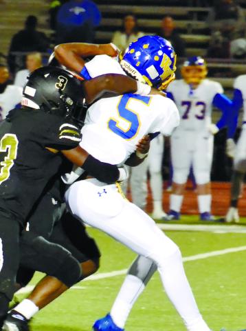 BJ Mullens (3) and another Tigers’ defender bring down a Washington-Wilkes’ ball-carrier in Greene County’s 20-10 win. BRENDAN KOERNER/Staff