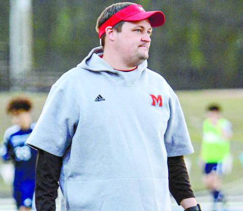 Morgan County boys soccer coach Aaron Paul directs players from the sideline of the Bulldogs’ tie with Apalachee High School March 16 in Winder.