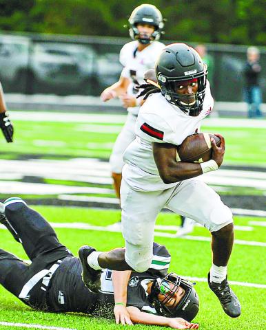 Morgan County running back Jaydon Dorsey (1) runs over a Walnut Grove defender. CHARLES JORDAN/Contributed