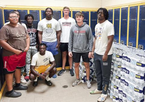 Members of the Morgan County High School Quarterback Club deliver water to Warren County. (CONTRIBUTED)