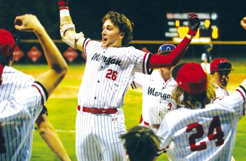 Morgan County senior Skylar McCoy (26) celebrates with teammates after hitting a three-run homer, which solidifed the Dogs’ victory as they run-ruled Newton 13-2 on March 12. LANCE MCCURLEY/Staff