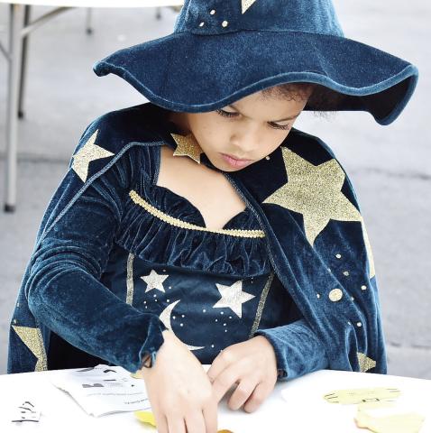 A young witch creates a skeleton during Halloween at The Plaza Oct. 25. HANNAH BARRON/Staff