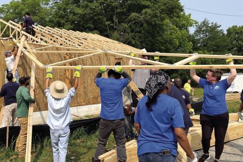Georgia-Pacific Madison Plywood employees install roof trusses. CONTRIBUTED