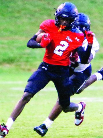 Morgan County wide receiver Jaylen Elder (2) tries to break away from a pair of Greene County defensive backs during a 3513 win over the Tigers on Sept. 6. LANCE McCURLEY/Staff