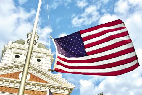 The flag flies at half-staff outside the Morgan County Courthouse Sunday, in memory of Greene County Fire Rescue Battalion Chief Chris Eddy. (HANNAH BARRON/Staff)