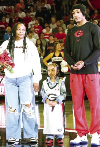 Former Morgan County basketball player Tyrin Lawrence with his mom and his son during Georgia basketball’s Senior Day celebration on Saturday. LANCE MCCURLEY/Staff